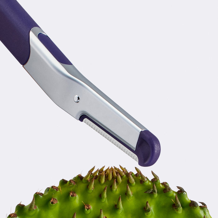Flamingo Refillable Dermaplane Razor angled towards a green prickly pear cactus leaf
