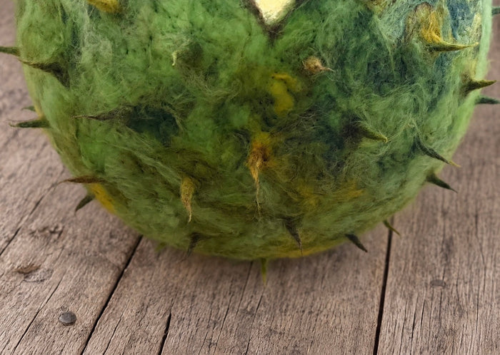 Organic green hand-felted wool texture on chestnut shell newborn photography prop