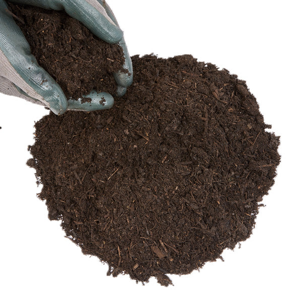 A person wearing gardening gloves is holding and displaying a handful of green organic compost.