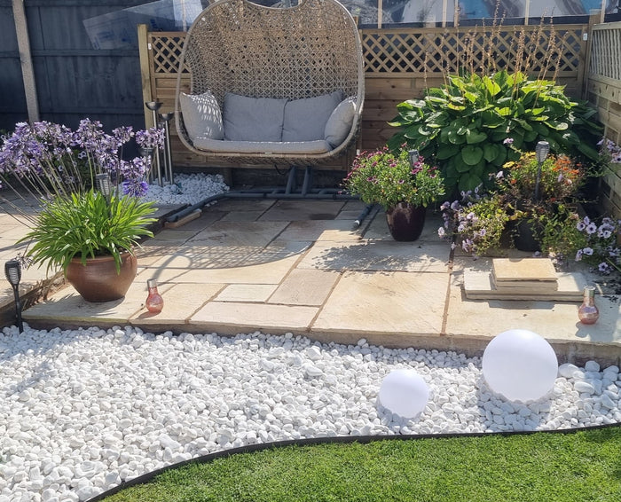 Stunning garden design using pebbles in the border