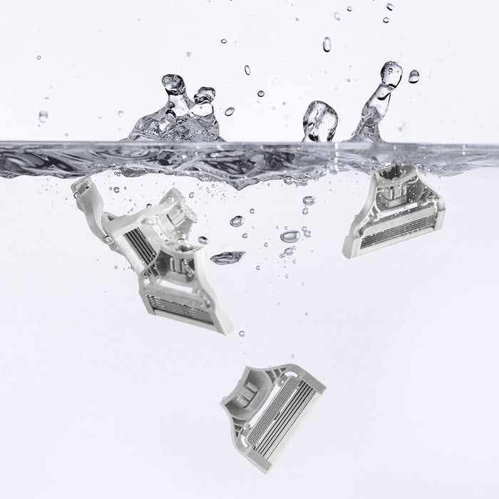 4 Pubic Blades floating in water with water splashing back on the surface.