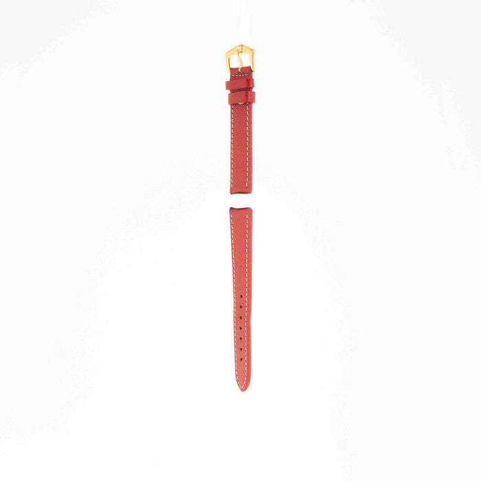 Angled view of Red Hammered Calfskin strap with ecru stitching and gold buckle, highlighting its slim profile and craftsmanship.