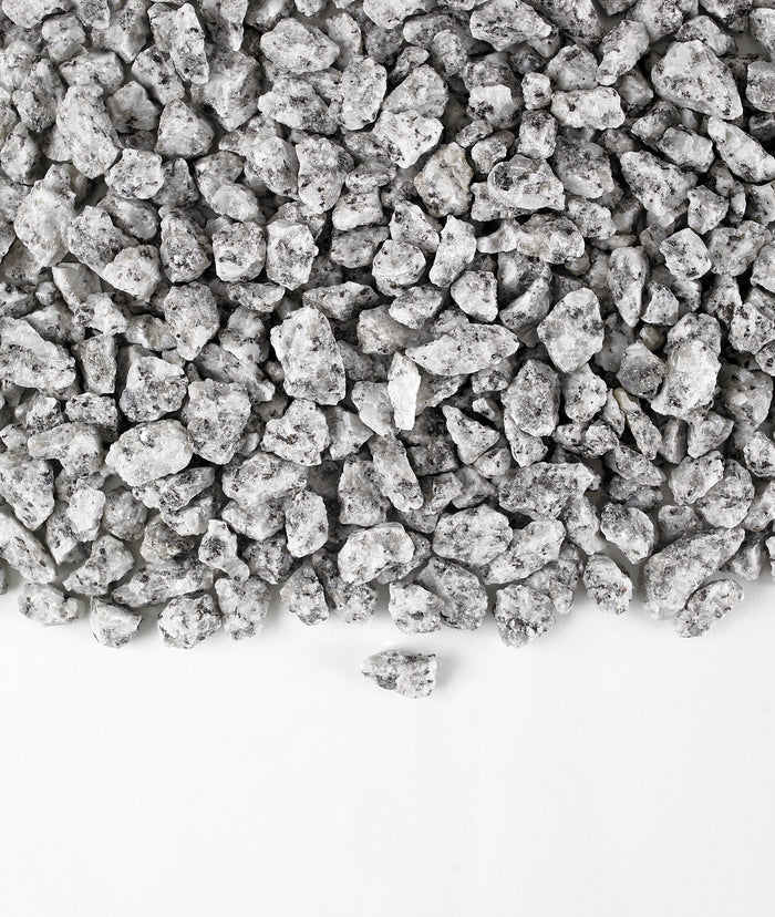 A close-up image of Silver Blue Granite Gravel chippings against a white background.