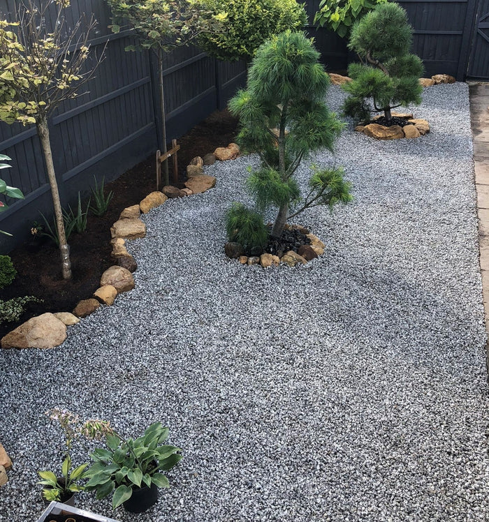 A customer's garden showcasing their granite gravel laid in a border with planted trees